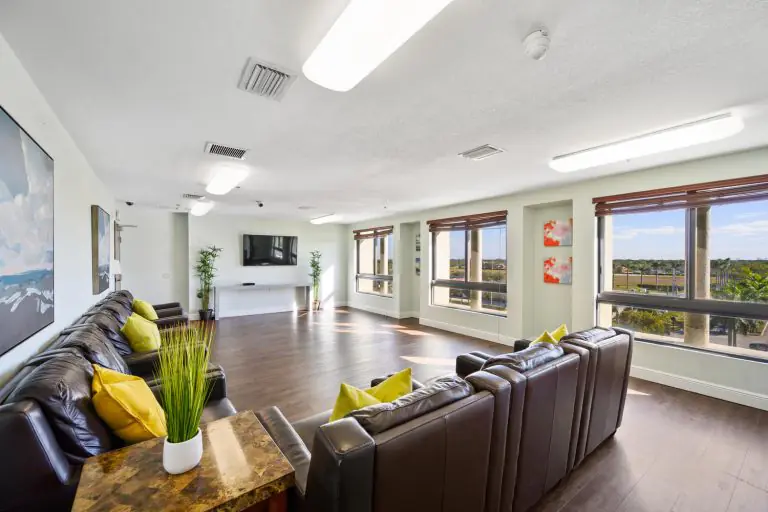 Recovery lounge with leather sectional seating, TV and large windows
