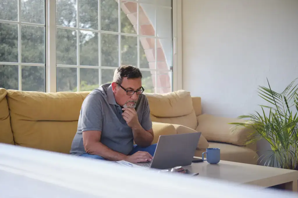man working on laptop at home on sofa 2026 09 25 01 35 50 utc