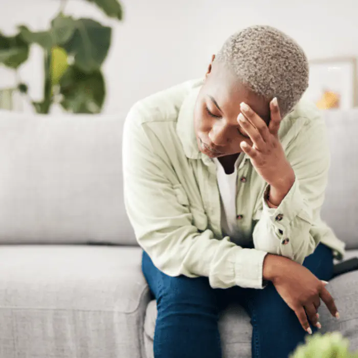 Person on couch, distressed, representing Valium detox support