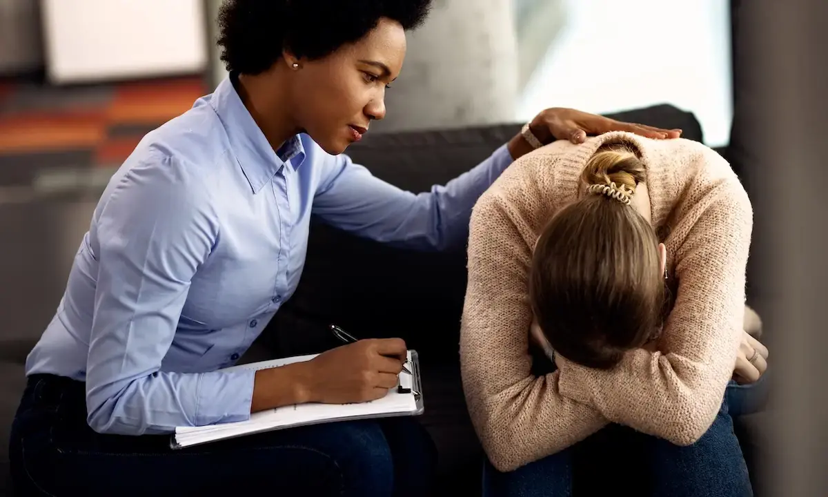 Therapist comforting a distressed woman during a counseling session