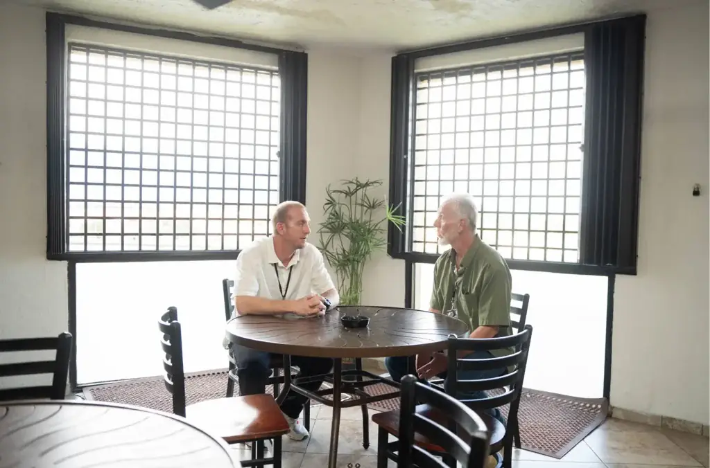 Florida Helps staff member consulting with client at a round table