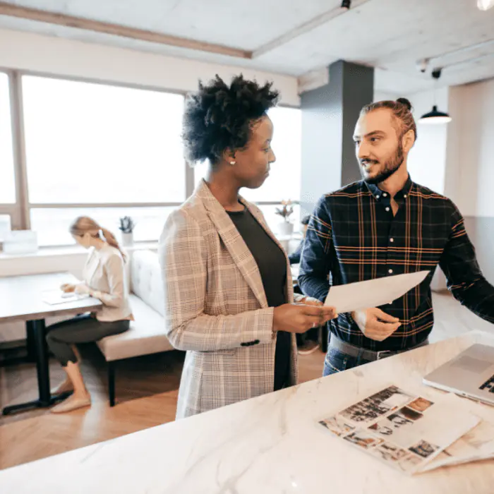 Two people discussing a loved one's detox support plan in a bright office